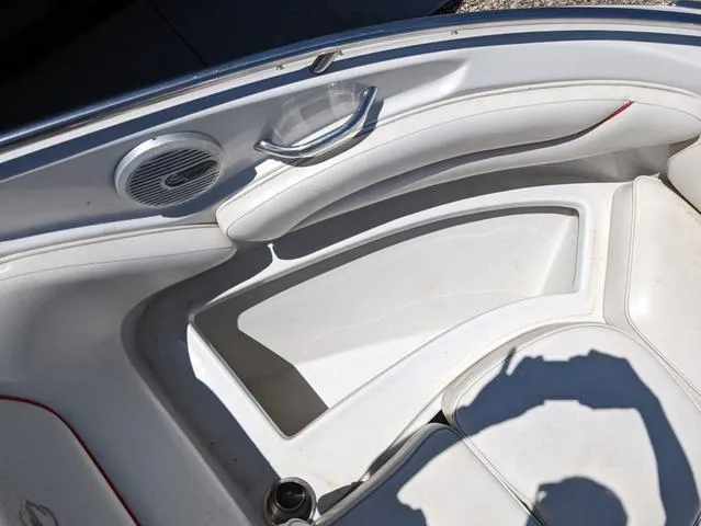 Slide: The Image of Interior of 2006 Crownline 220 LS boat, featuring white seating and speaker. - 17