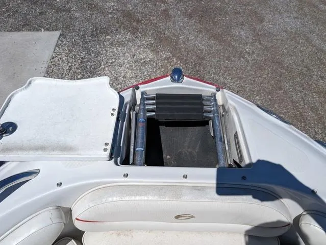 Slide: The Image of 2006 Crownline 220 LS boat with open storage compartment and ladder. - 18