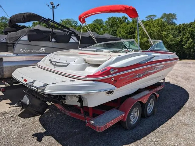 Slide: The Image of 2006 Crownline 220 LS boat on a trailer with red accents and canopy. - 22