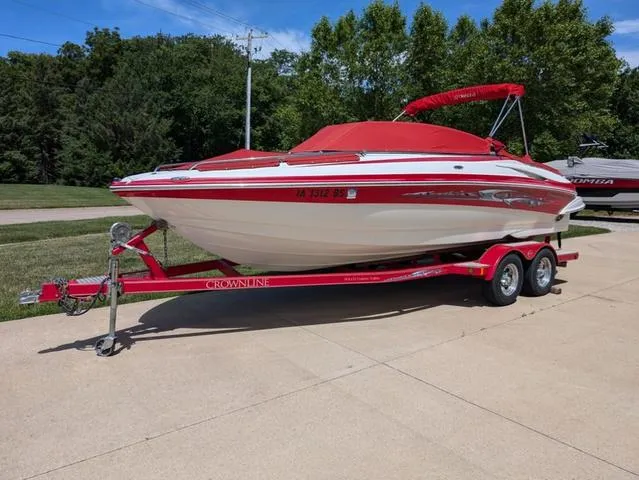 Slide: The Image of 2006 Crownline 220 LS boat with red cover on trailer, parked outdoors. - 24