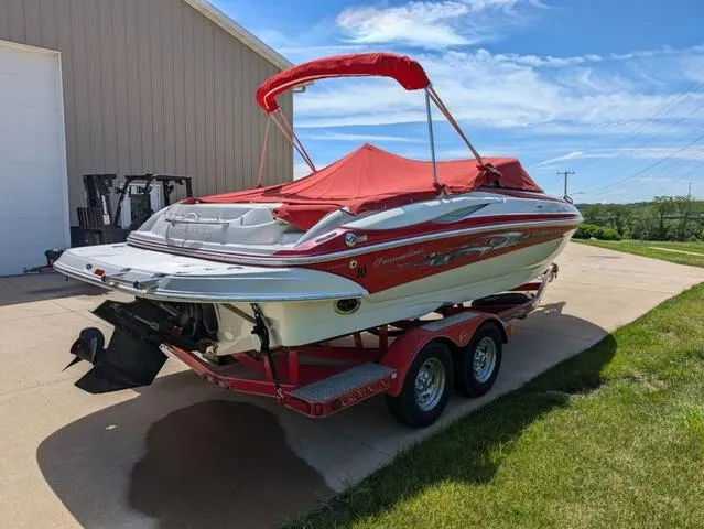 Slide: The Image of 2006 Crownline 220 LS boat with red cover on trailer, parked outdoors. - 3