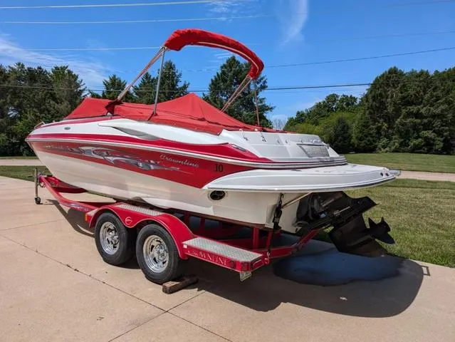 Slide: The Image of 2006 Crownline 220 LS boat with red canopy on trailer, parked outdoors. - 4