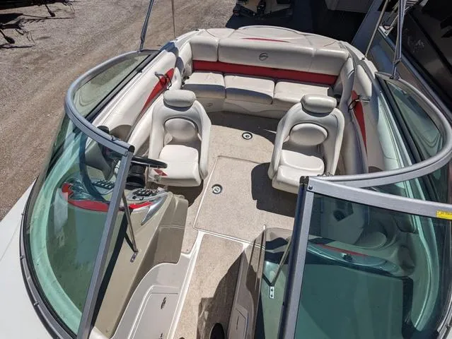 Slide: The Image of 2006 Crownline 220 LS boat interior with beige seating and red accents. - 7