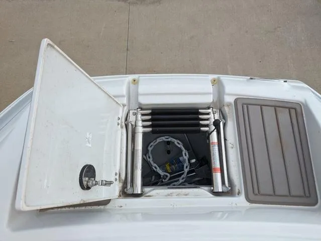 Slide: The Image of 2022 Crownline E235 XS boat storage compartment with ladder and chain. - 14