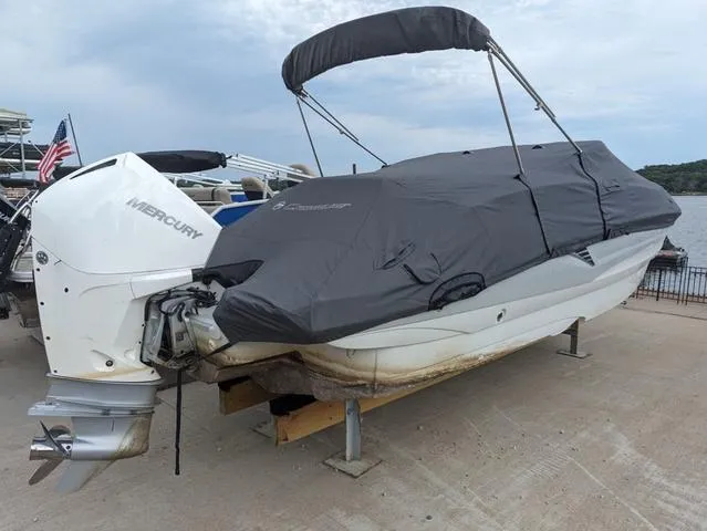 Slide: The Image of 2022 Crownline E235 XS boat with cover and Mercury outboard motor. - 18