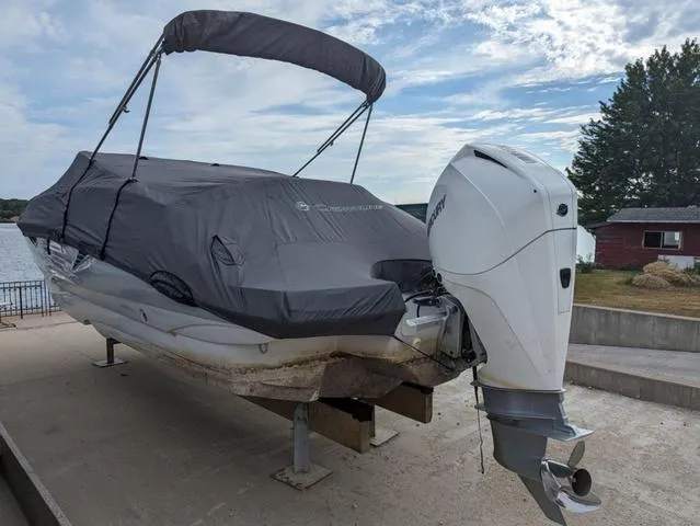 Slide: The Image of 2022 Crownline E235 XS boat with cover and outboard motor on a dock. - 19