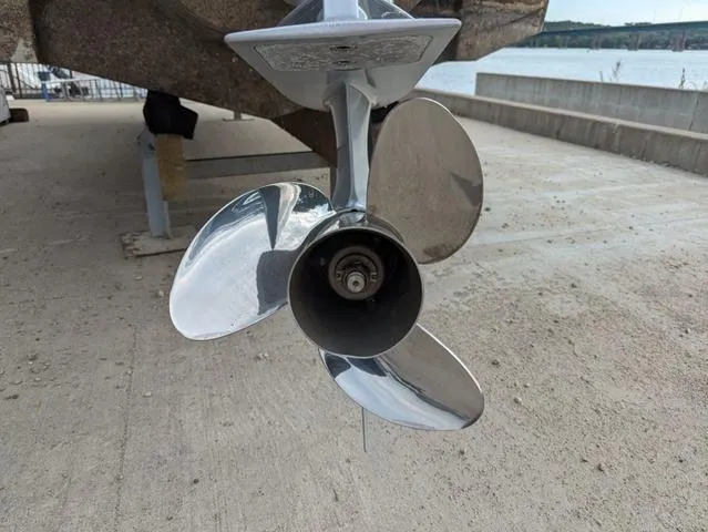 Slide: The Image of 2022 Crownline E235 XS boat propeller on a concrete dock near water. - 20