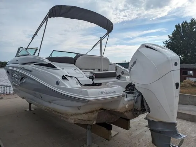 Slide: The Image of 2022 Crownline E235 XS boat with outboard motor on a dock. - 3