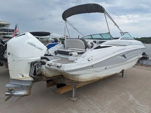 Slide: The Image of 2022 Crownline E235 XS boat with Mercury outboard engine, docked on a sunny day. - 4