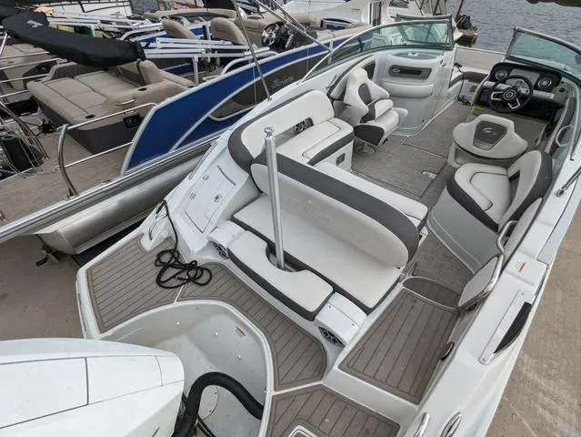 Slide: The Image of 2022 Crownline E235 XS boat interior with modern seating and dashboard. - 5