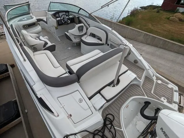 Slide: The Image of 2022 Crownline E235 XS boat interior with white seating and modern dashboard. - 6