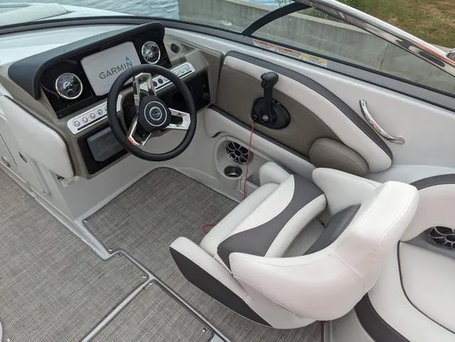 Slide: The Image of 2022 Crownline E235 XS boat cockpit with Garmin navigation system and modern steering wheel. - 9