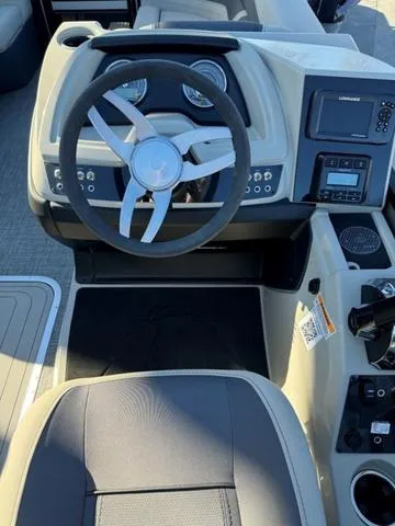 Slide: The Image of 2023 Barletta C22UC boat dashboard with steering wheel and control panel. - 6
