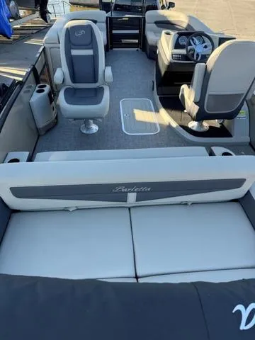 Slide: The Image of 2023 Barletta C22UC boat interior with seating and steering console. - 7