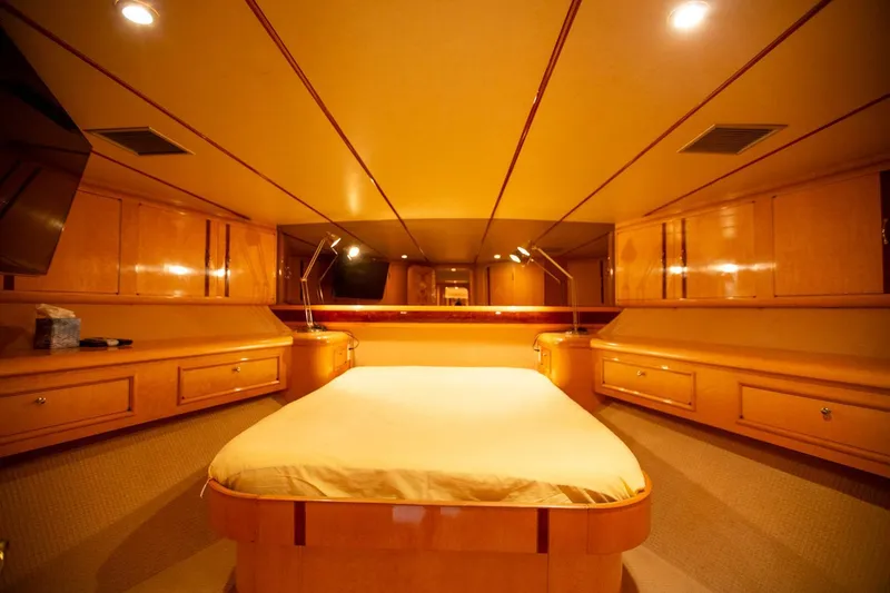 Slide: The Image of Luxurious 1999 Tarrab Motoryacht bedroom with elegant wood finish and ambient lighting. - 11