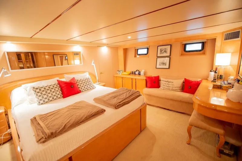 Slide: The Image of Luxurious 1999 Tarrab Motoryacht bedroom with cozy bed, elegant decor, and warm lighting. - 18