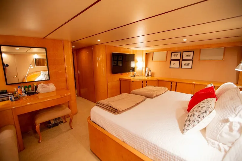 Slide: The Image of Luxurious 1999 Tarrab Motoryacht bedroom with elegant wood finishes and cozy decor. - 20