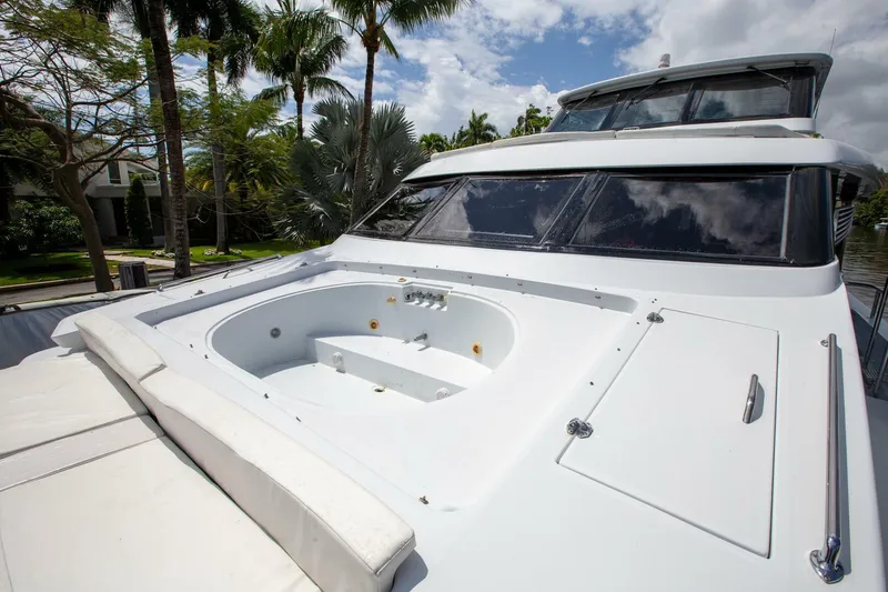 Slide: The Image of Tarrab 1999 motoryacht with deck jacuzzi, surrounded by lush palm trees. - 40