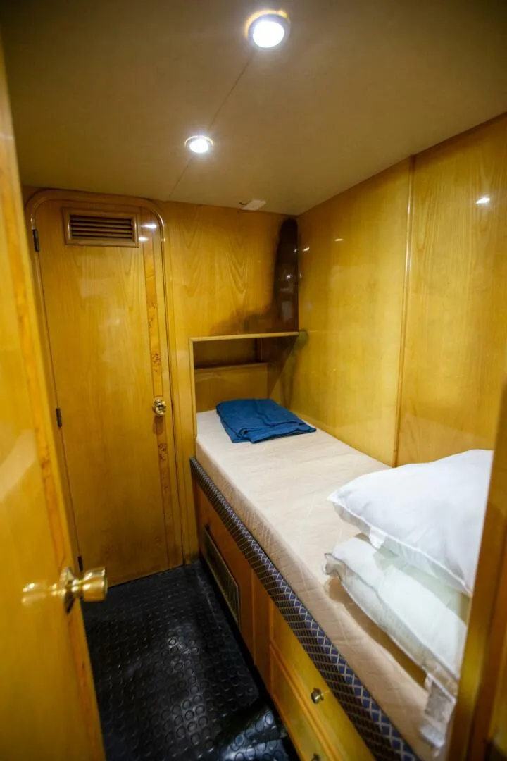 Slide: The Image of Cozy cabin interior of 1999 Tarrab Motoryacht with wooden paneling and single bed. - 47