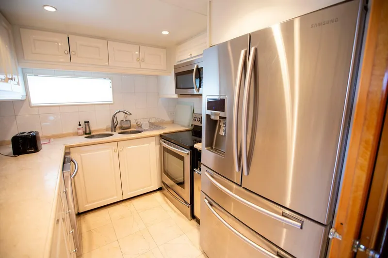 Slide: The Image of Modern kitchen in 1999 Tarrab motoryacht with stainless steel appliances and white cabinetry. - 49