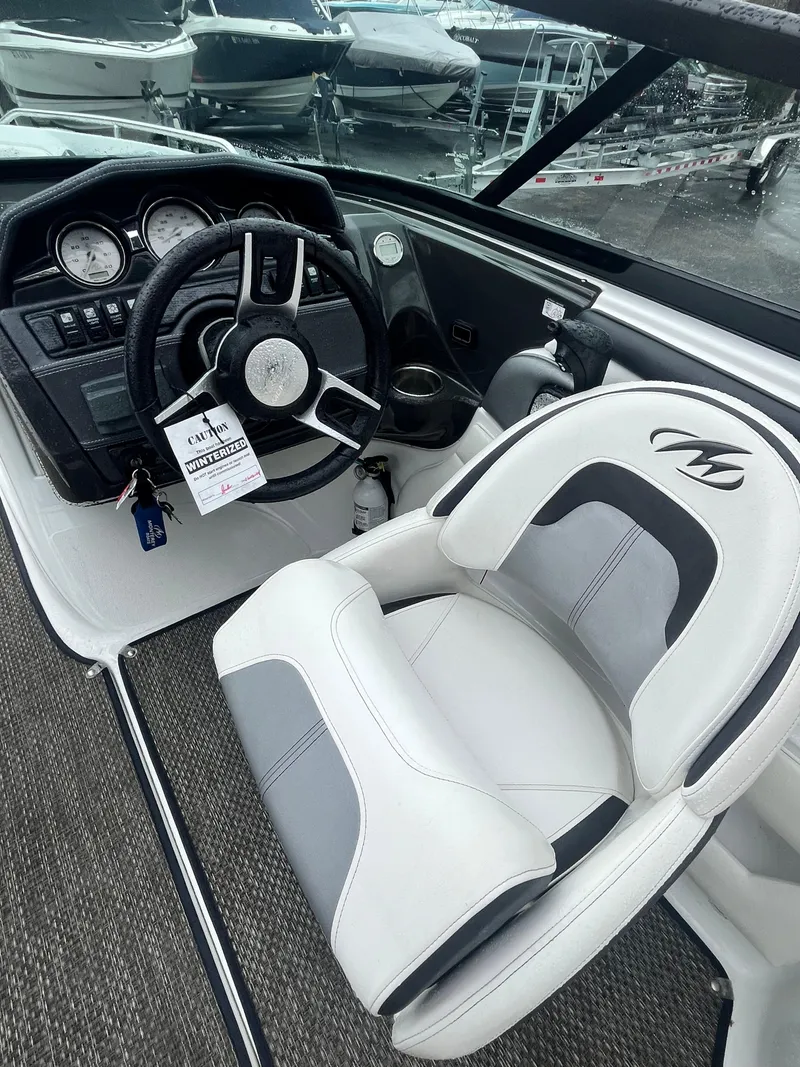 Slide: The Image of 2017 Monterey 224FS boat interior with steering wheel and captain's seat. - 12