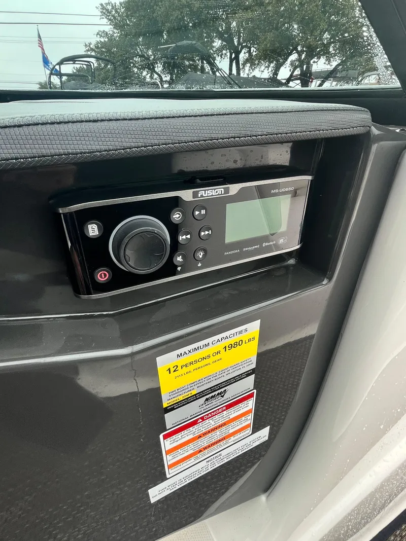 Slide: The Image of 2017 Monterey 224FS boat dashboard with Fusion stereo system and capacity warning label. - 15