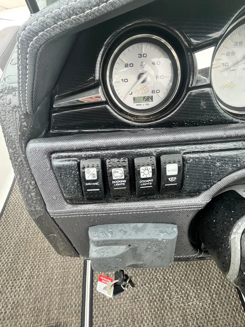 Slide: The Image of Dashboard of a 2017 Monterey 224FS boat with gauges and control switches. - 17