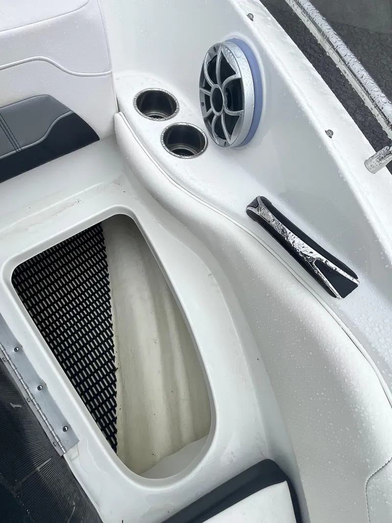 Slide: The Image of 2017 Monterey 224FS boat interior with speaker, cup holders, and storage compartment. - 22