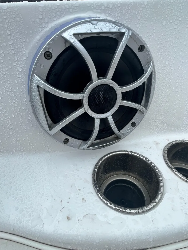 Slide: The Image of Close-up of a 2017 Monterey 224FS boat speaker and cup holders with water droplets. - 24