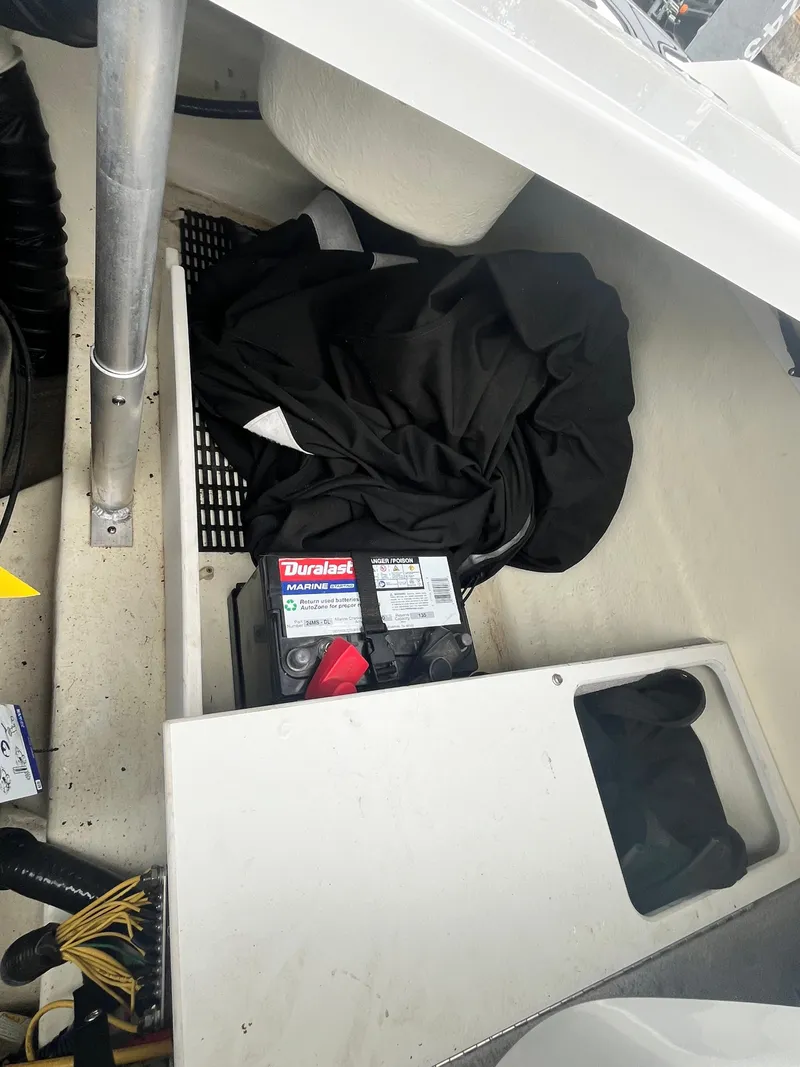 Slide: The Image of 2017 Monterey 224FS boat interior with Duralast battery and black cover. - 8