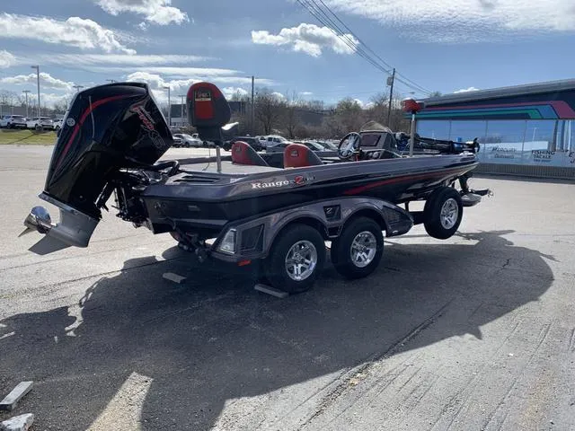 Slide: The Image of 2024 Ranger RZ519C boat with dual axle trailer in a parking lot. - 3