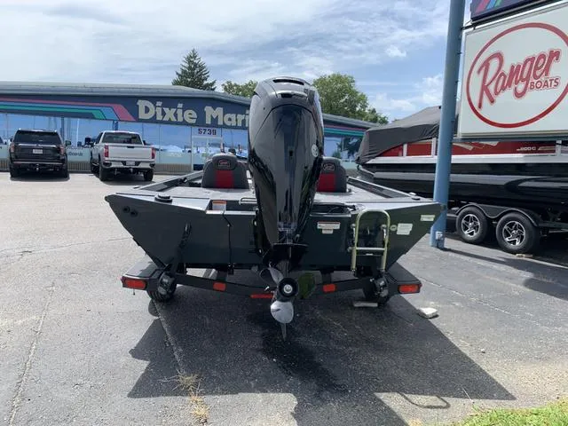 Slide: The Image of 2024 Ranger RT178 boat at dealership, rear view with motor, parked outdoors. - 5