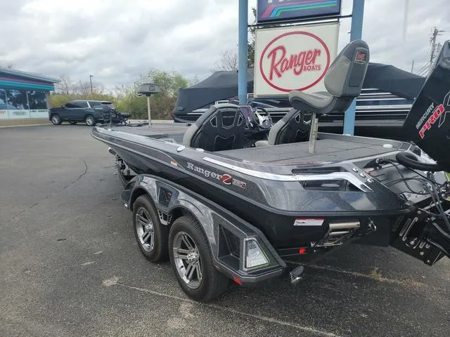 Slide: The Image of 2025 Ranger Z520R Ranger Cup boat in dealership lot, showcasing sleek design and dual axle trailer. - 14