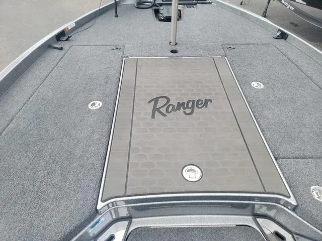 Slide: The Image of 2025 Ranger Z520R Ranger Cup boat deck with logo, gray carpet, and storage compartments. - 6