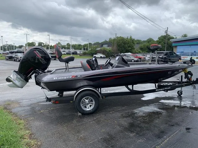 Slide: The Image of 2025 Ranger Z185 boat on trailer, parked outdoors under cloudy skies. - 4