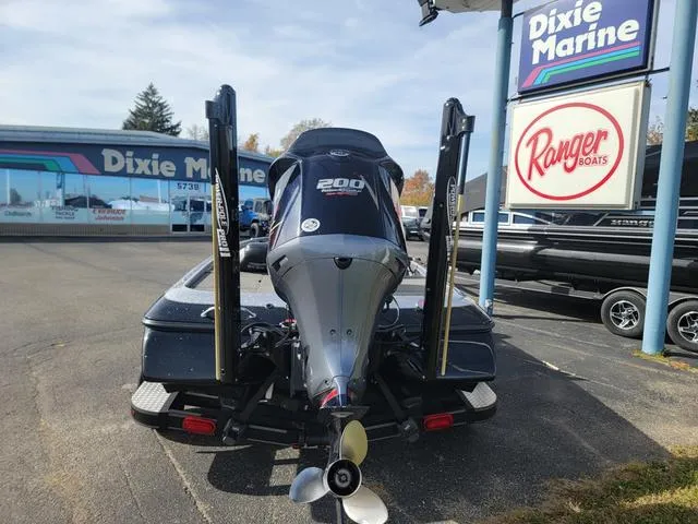 Slide: The Image of 2015 Skeeter ZX200 boat at Dixie Marine dealership, featuring powerful outboard motor. - 6