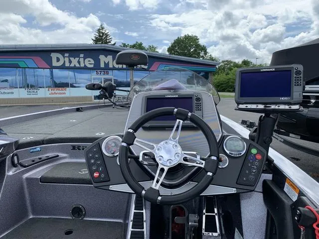 Slide: The Image of 2015 Ranger Z521C boat dashboard with steering wheel and navigation screens. - 4