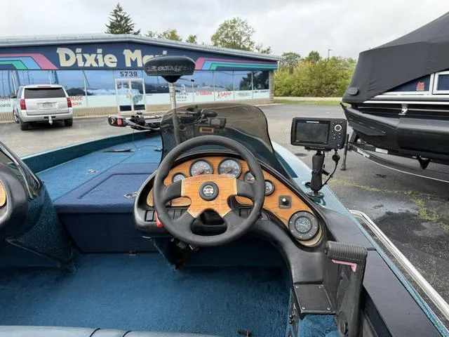 Slide: The Image of 1995 Ranger 482VS boat dashboard with steering wheel and gauges, parked at Dixie Marine. - 4