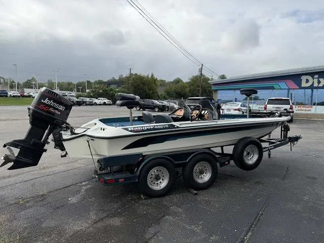 Slide: The Image of 1995 Ranger 482VS boat with Johnson 150 engine on a trailer in a parking lot. - 6