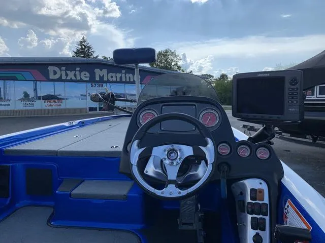Slide: The Image of 2009 Stratos 285XL boat dashboard with steering wheel and electronics at Dixie Marine. - 4