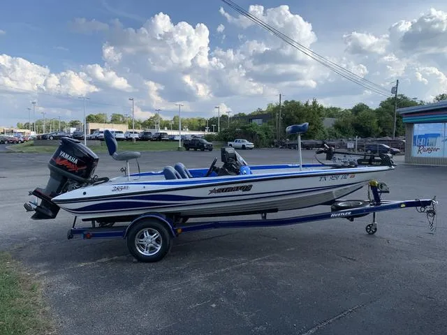 Slide: The Image of 2009 Stratos 285XL boat with Yamaha motor on trailer, parked outdoors. - 5
