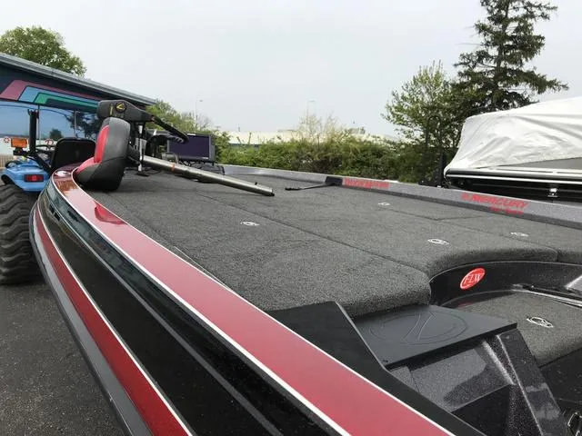 Slide: The Image of 2019 Ranger Z520L bass boat with fishing rod on deck, parked outdoors. - 4