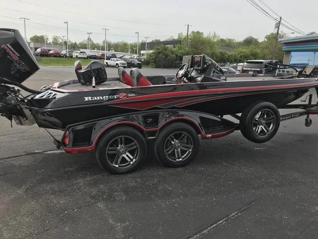 Slide: The Image of 2019 Ranger Z520L bass boat with trailer, black and red design, parked outdoors. - 5