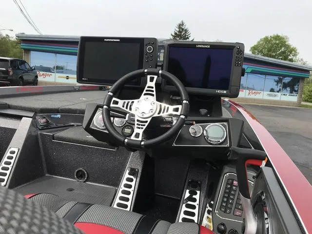 Slide: The Image of 2019 Ranger Z520L boat dashboard with dual fish finders and steering wheel. - 8