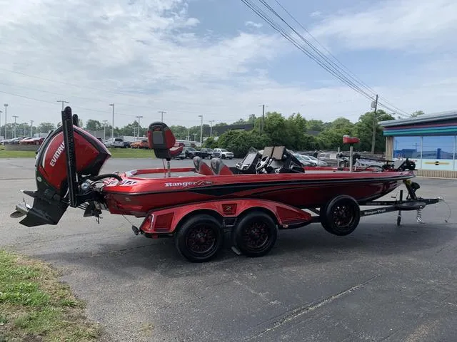 Slide: The Image of 2020 Ranger Z521L boat with trailer, red and black design, parked outdoors. - 1