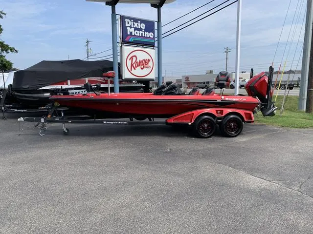 Slide: The Image of 2020 Ranger Z521L boat in red, parked at Dixie Marine dealership. - 2