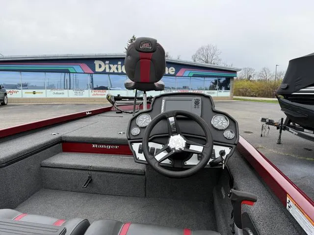 Slide: The Image of 2019 Ranger RT178 boat interior with steering wheel and seating, parked near Dixie Marine. - 4