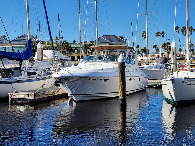 Slide: The Image of 1999 Cruisers Yachts 3375 Esprit docked in a marina with sailboats. - 0