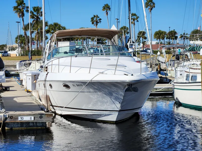 Slide: The Image of 1999 Cruisers Yachts 3375 Esprit docked in a sunny marina. - 1