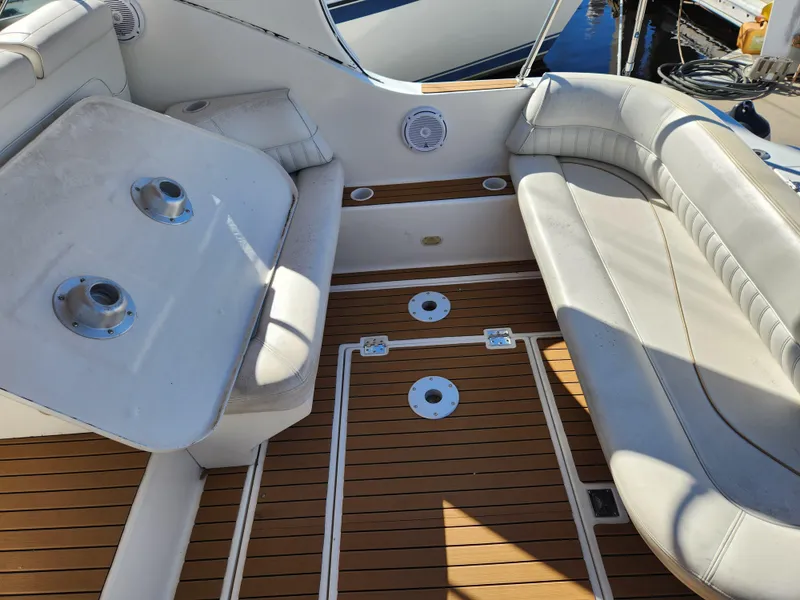 Slide: The Image of 1999 Cruisers Yachts 3375 Esprit interior with white seating and wooden flooring. - 10